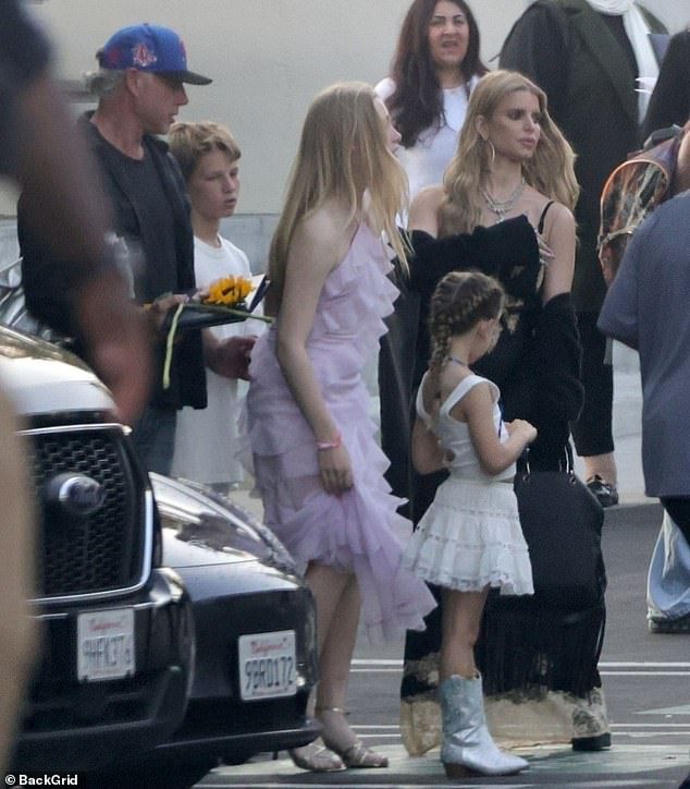 Dressed in a simple yet elegant black dress, the 44-year-old pop star kept a serious expression while spotted outside a restaurant with the former NFL player, 45