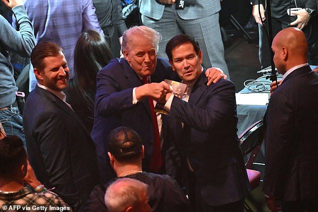 President Donald Trump bumps fists withUS Secretary of State Marco Rubio at UFC 316