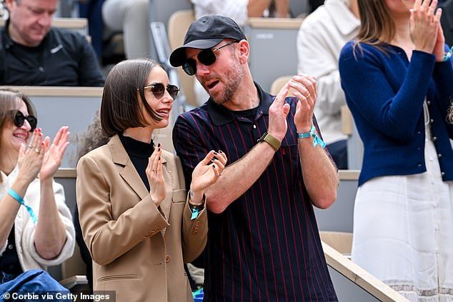 Charlie cut a casual figure for the outing as he stepped out in a navy blue and red striped YSL shirt layered over a black T-shirt