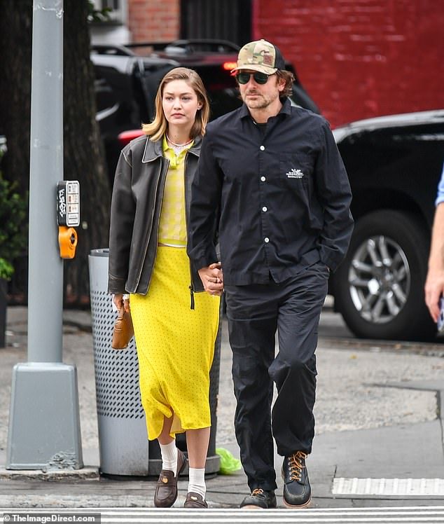 Bradley kept it casual in a black button down, trousers, rugged footwear and camouflage print hat