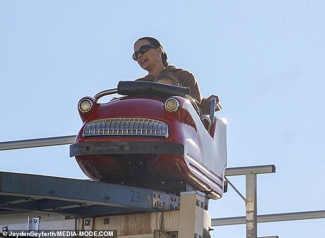 Katy was spotted showing off a rare smile while riding one of the attractions with Daisy