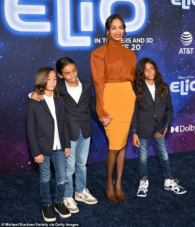 The Oscar winner - turning 47 next week - dressed her 10-year-old twin sons Cy Aridio & Bowie Ezio and eight-year-old son Zen Anton Hilario in matching black blazers over white button-up shirts, blue jeans, and sneakers