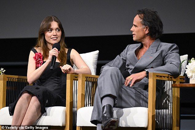 Walton, 53, kept it dapper in a grey suit and black boots as he sat beside Aimee during the panel at the event