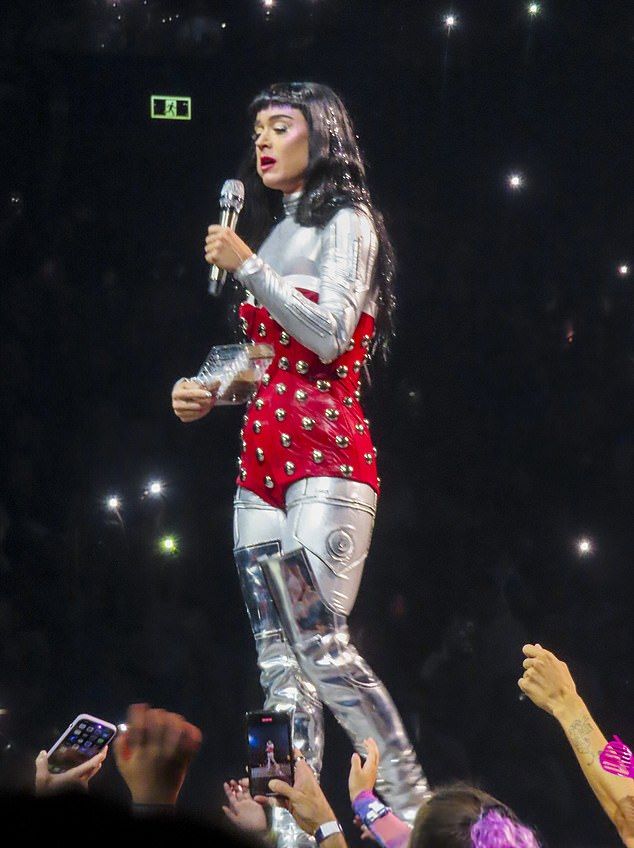 She donned a red, studded bodysuit paired with a long sleeved silver top