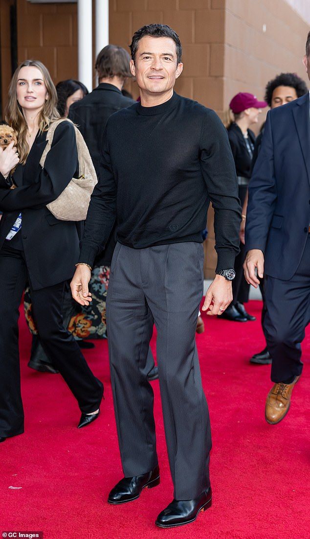 Bloom kept it smart and sharp for the premiere with a black long-sleeve shirt and slacks
