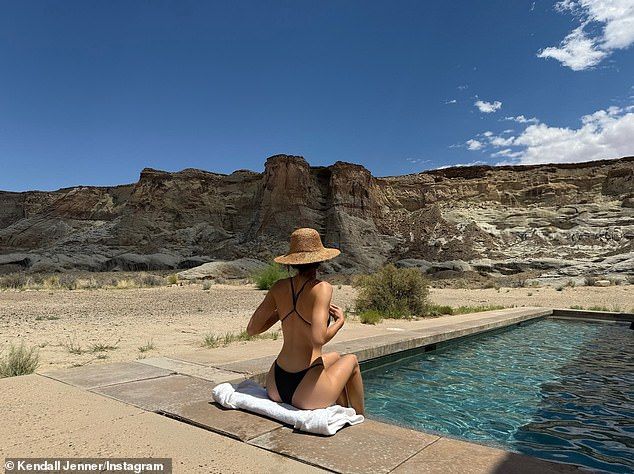 The fashionista added a straw hat as she sat poolside