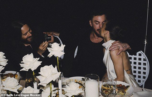 The 53-year-old Oscar winner (L) appeared to be in great spirits as he helped serve photographer duties at the 55-year-old drummer (M) and the 41-year-old actress' (R) intimate nuptials