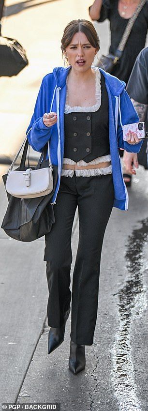 Aimee - who plays Chelsea, the free-spirited young girlfriend of Rick (Walter) in the series - donned a blue hoodie over her chic black co-ord as she exited the Los Angeles studios after filming