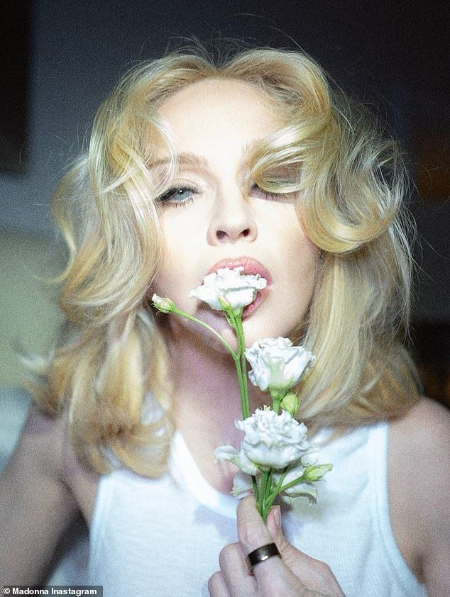 Madonna teamed the look with tan stockings and styled her golden locks into a bouncy blowout as she gave her followers a treat for their eyes