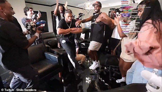 Sanders (center right) celebrates with his friends and family after finally being drafted