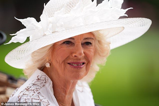 Queen Camilla completed her Ascot look for today with a feathered Philip Treacy hat
