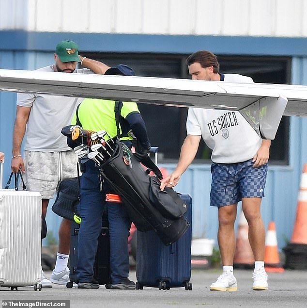 Baggage handlers were carrying a set of golf clubs ahead of Kelce's appearance in an event