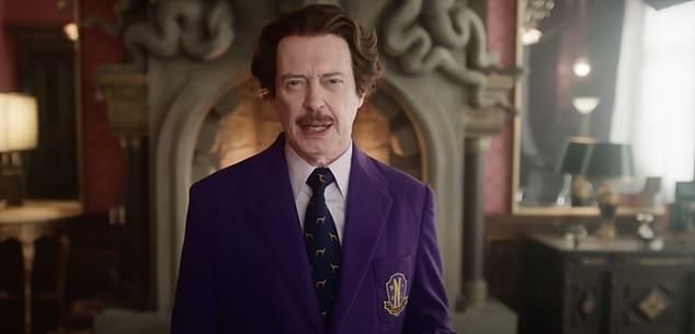 The 67-year-old actor is clad in a purple suit, explaining to viewers, 'Last year, this school, this sanctuary, came under attack, thanks to my predecessor, Larissa Weems'