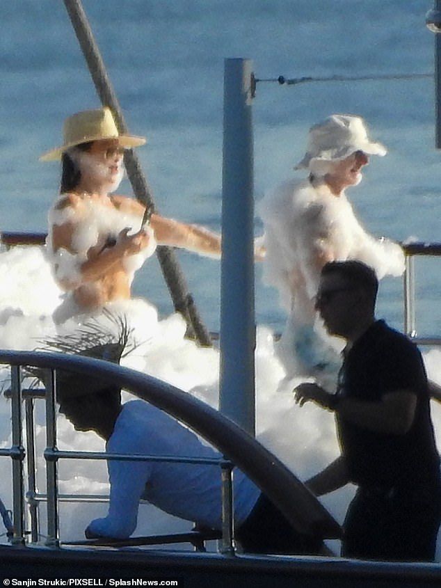 Pictures obtained by DailyMail.com of the lavish celebration show the loved-up couple covered in soap suds and all smiles as they relished in the summer sunshine