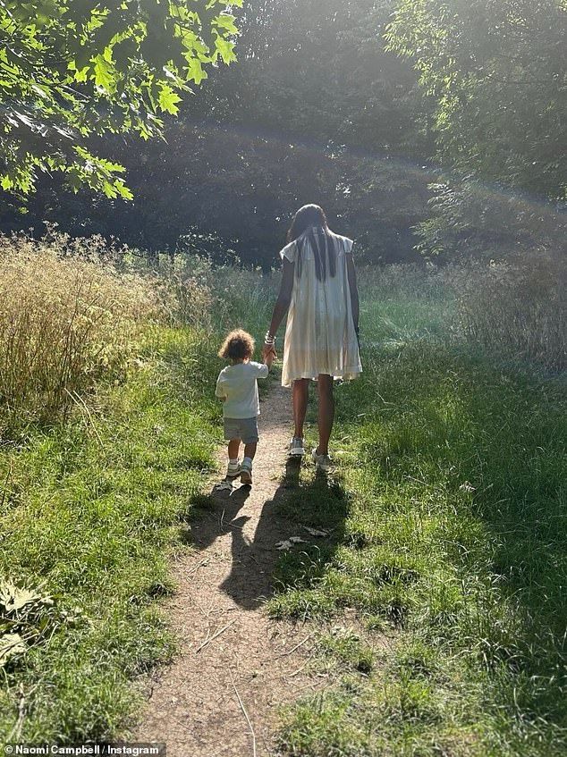 Other snaps showed Naomi strolling through the woods with her son as she wore a white smock dress