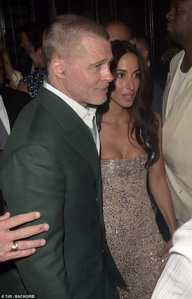 The Hollywood actor, 61, cut a dapper figure as he led the stunning 32-year-old, through crowds to the bash