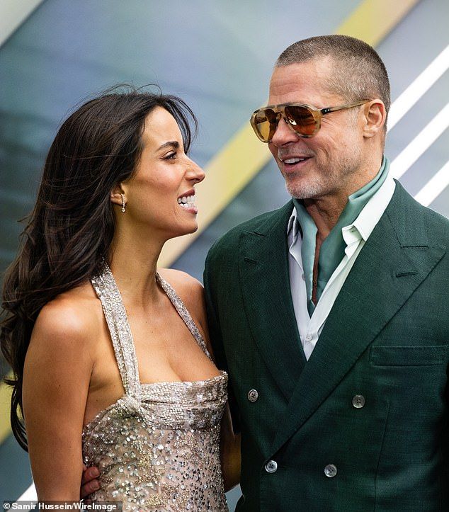 Judi said: 'Ines's poses look very self-assured and independent here. While Brad leans his torso in towards hers she arches her back and throws her dazzling smiles at the cameras