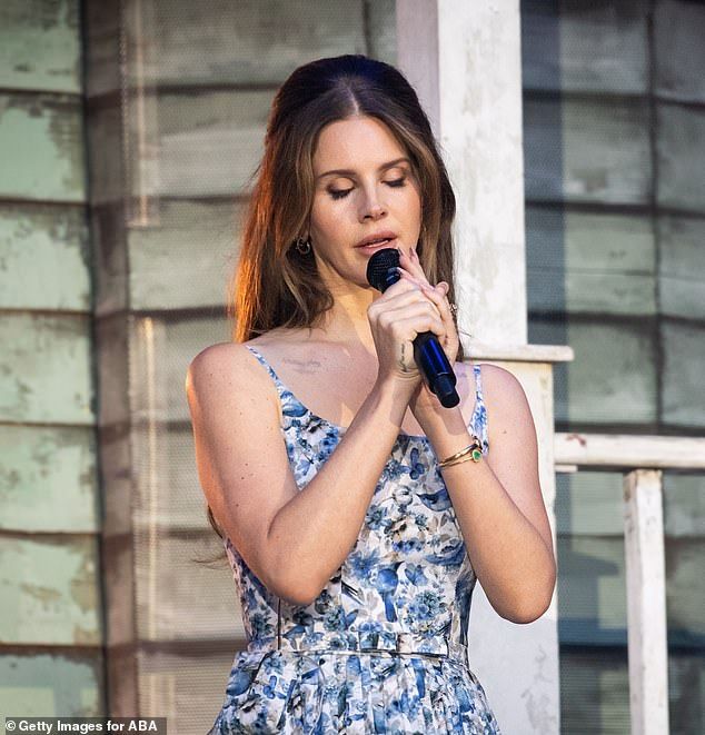 During the performance, the Summertime Sadness hitmaker wore a blue, floral tea dress as she walked around her Southern home porch-inspired set and sang her hits