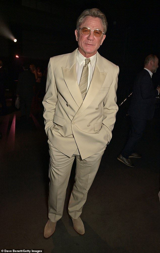 Daniel Craig looked incredibly suave in a beige double-breasted blazer and matching trousers as he posed for the cameras at the event