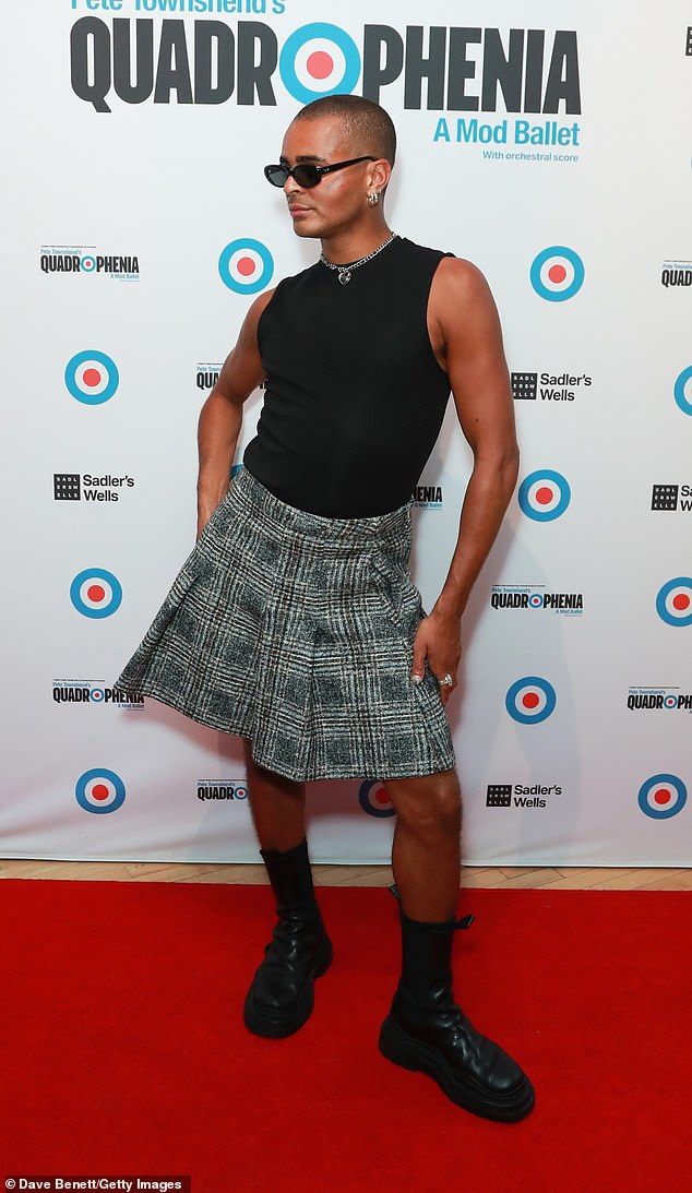 Layton Williams, 30, wowed in a black and grey plaid skirt which he paired with a black tank top and black leather boots