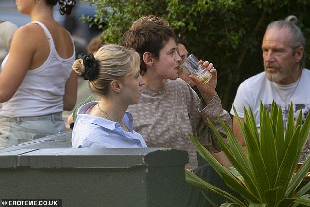 The Crown star sipped on a pint in the sun and at one point was pictured covering their face as they laughed and joked