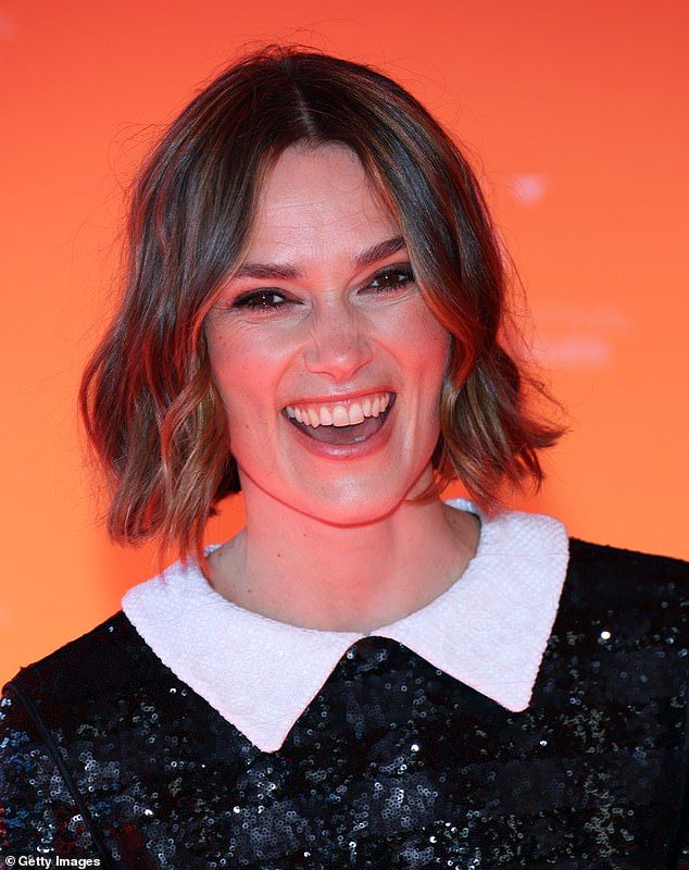 She boosted her height in black heels and flashed her dazzling white smile while posing for snaps