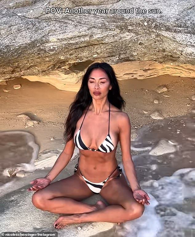 Scherzinger additionally shared another video as she flashed her sculpted abs while meditating near the ocean