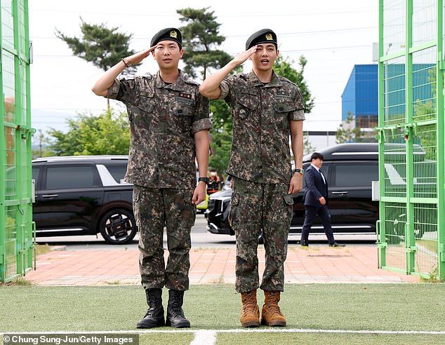 One day earlier, leader/rapper RM (L) and singer V (R) were also photographed as they were discharged from their mandatory military service in Chuncheon