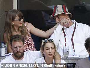 She wore a red and white gingham Reformation gown and dark shades. Taylor is seen at the US Open last year