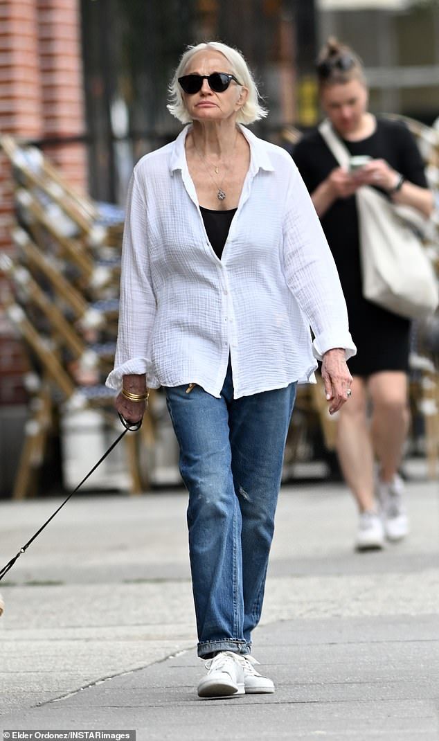 The 71-year-old actress wore a button-up white linen shirt over a black camisole, adding a pair of blue jeans and white sneakers