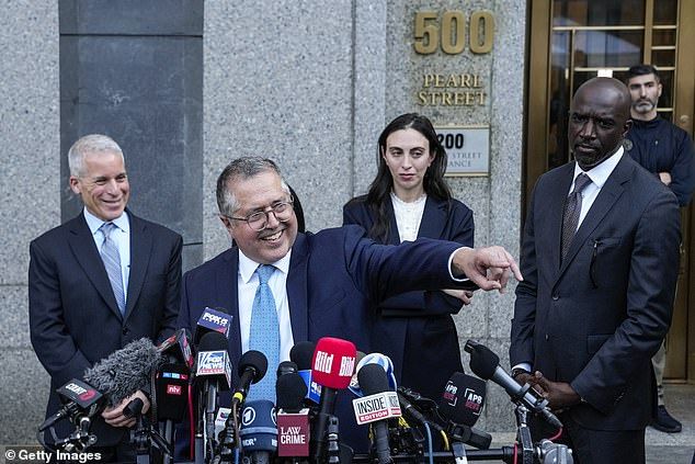 An elated Marc Agnifilo, Diddy's lead defense attorney, stands between fellow attorneys Brian Steel, Teny Geragos and Xavier Donaldson after Diddy was acquitted