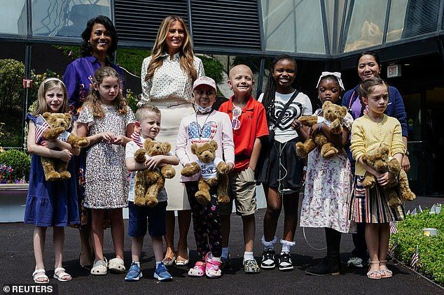 The First Lady also appeared to give the patients teddy bears that were holding small American Flags, as they posed together for pictures