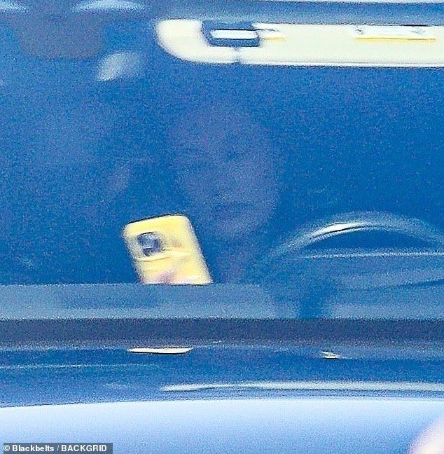 Elsewhere in the bustling city, his wife was seen cruising through the streets in a sleek vehicle. At one point, she was spotted glancing down at her phone in her hand
