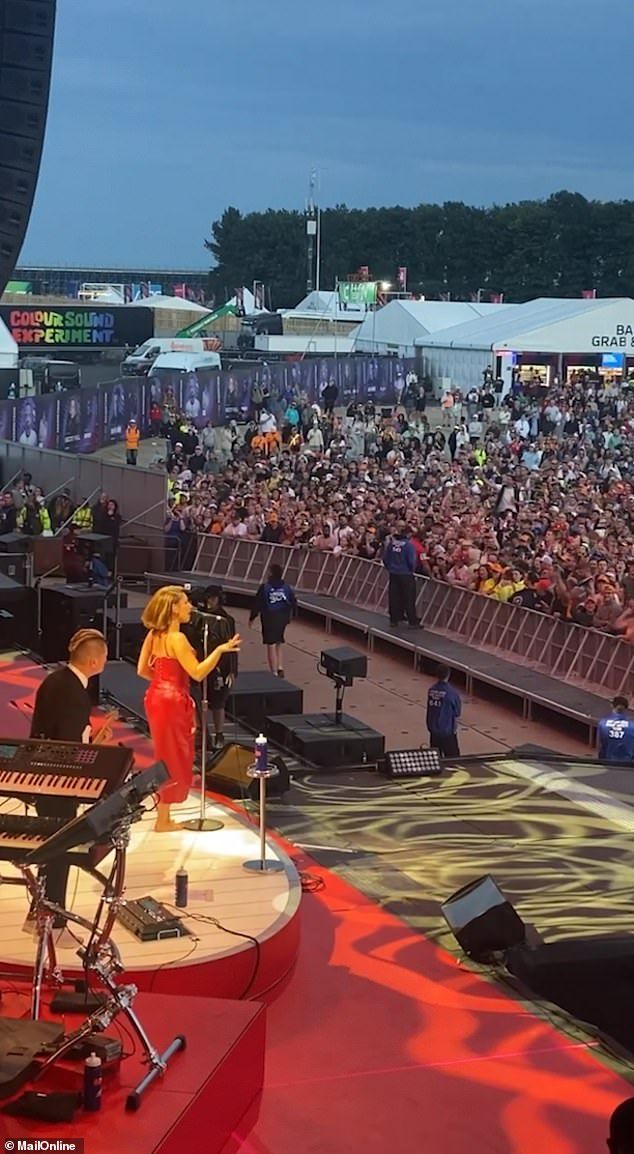 She looked sensational in a figure-hugging red leather gown, with Lewis barely able to take his eyes off her as he enjoyed the show
