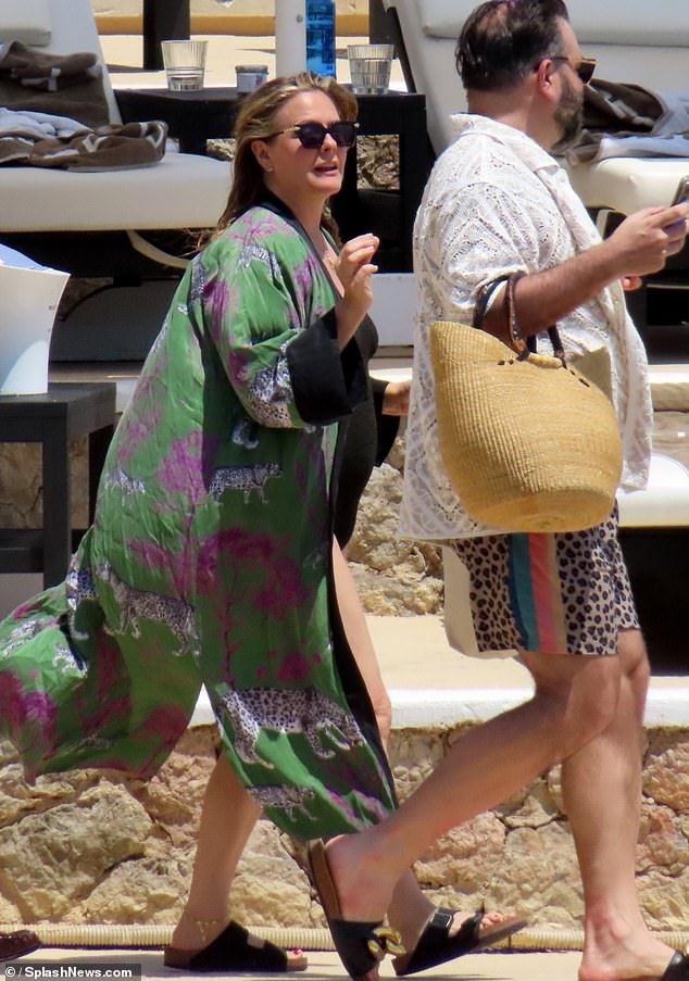 Alicia later added to her look with a colourful cover up and appeared fresh-faced with no makeup while out in the sun