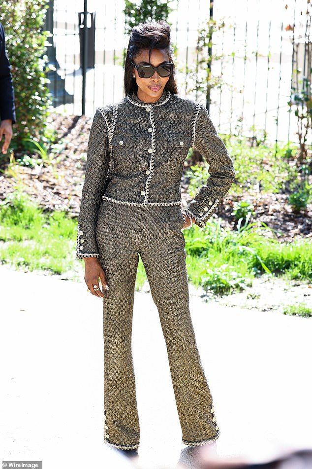 She oozed sophistication as she arrived wearing a black and gold tweed button-up jacket paired with matching suit trousers