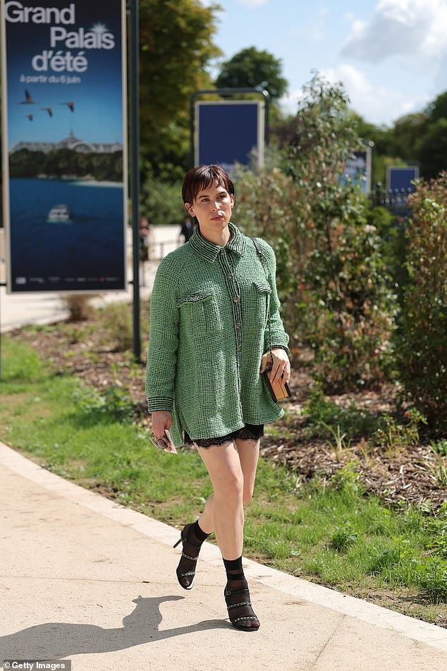 13 Reasons Why star Tommy Dorfman looked stunning in a longline green tweed shacket with leather heels and black sheer socks