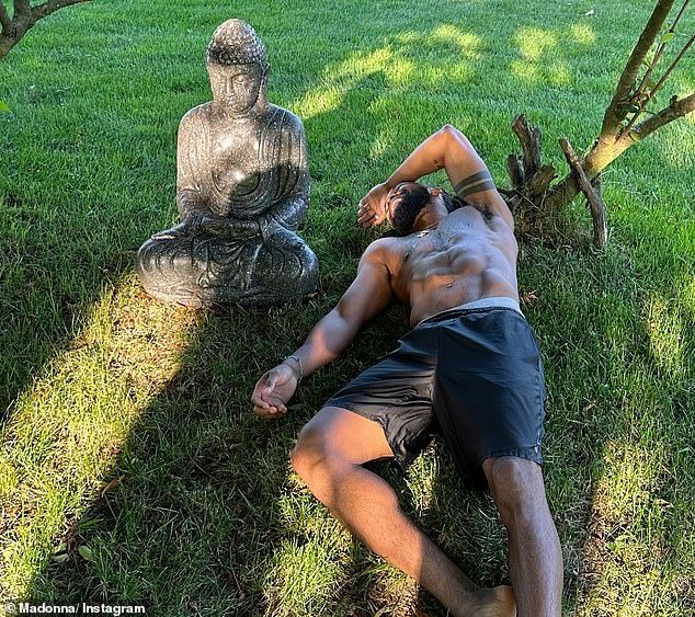 A shirtless Morris is pictured relaxing in the garden during Madonna's July 4 celebration