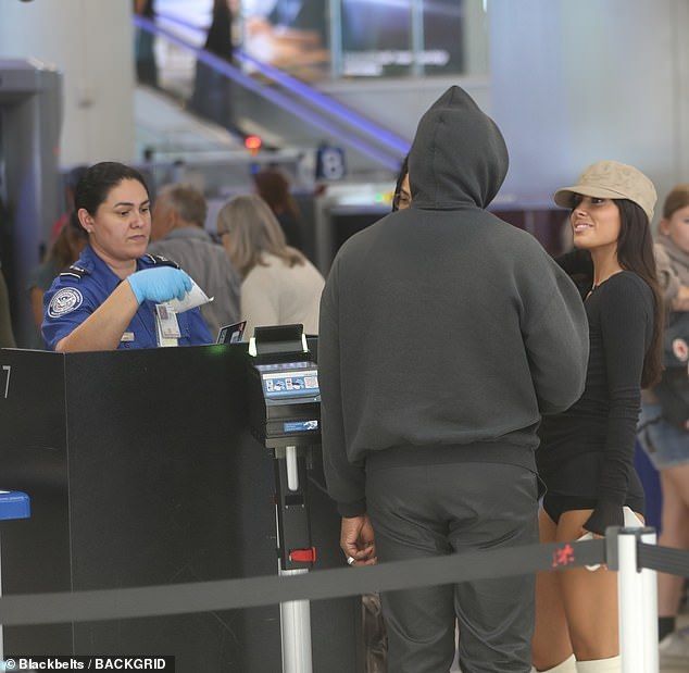 The rapper  who's been hit with another sexual assault claim  and the Australian architect, bypassed any VIP perks, and were seen standing in line for security with the rest of the crowd