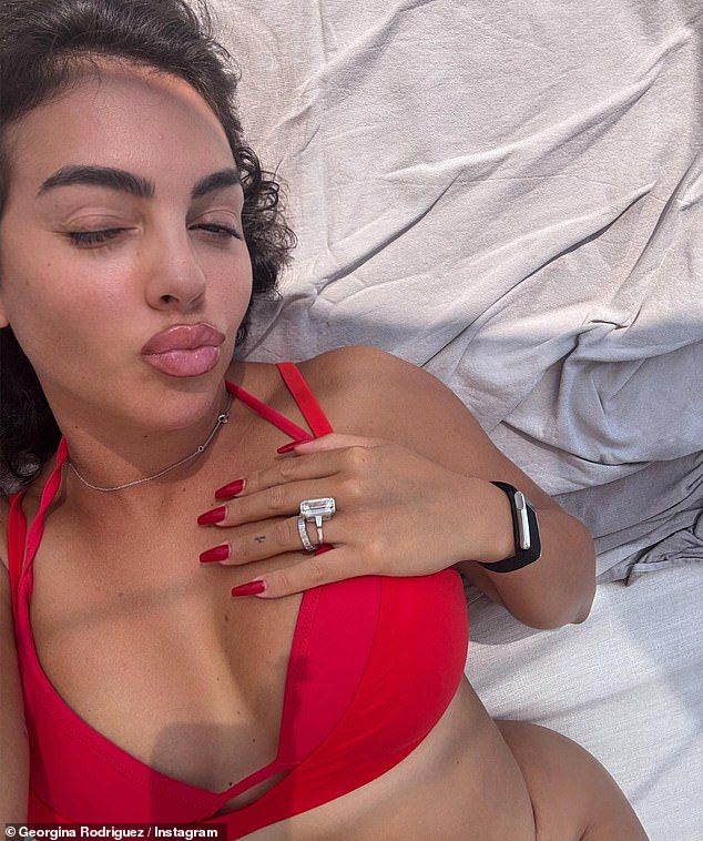 Georgina looked incredible in a red bikini as she flaunted her diamond ring