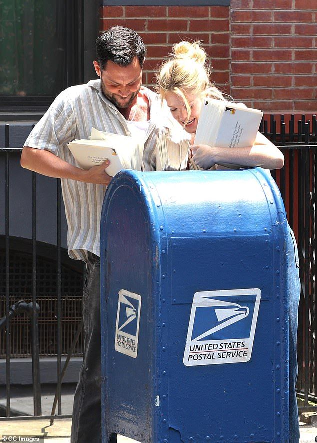 The pair were seen attempting to shove the envelopes into a letter box during filming