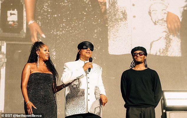 Arriving on stage, the legendary musician, 75, was dressed in a white tunic with stitched portraits of John and Marvin on either side