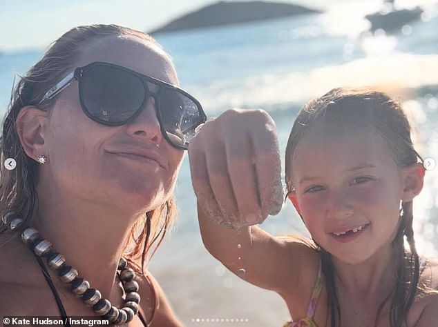 In one snaps on board the yacht she flaunted her toned abs in a brown bikini and gingham sarong as she posed with her daughter
