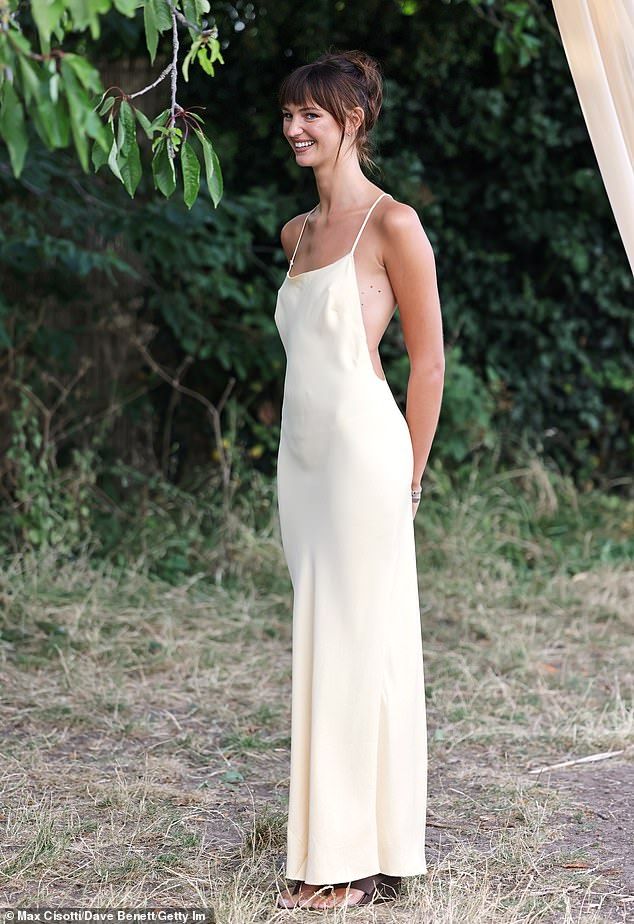 Mia Regan turned heads in a daring butter yellow backless gown as she attended an intimate dinner in London to celebrate her H&M collection on Monday evening