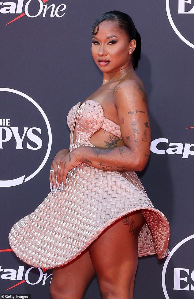 The eyebrow-raising dress resembled a sun hat and stuck out on both sides - and it was so short if left very little to imagination
