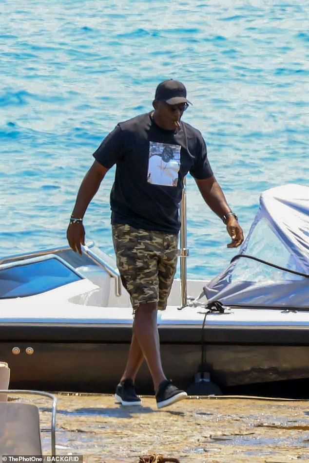Wearing a black baseball hat, camo shorts, sunglasses and Notorious B.I.G. t-shirt, Jordan didnt betray any emotion as he deboarded a motorboat for dry land