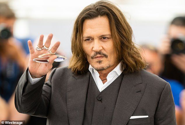 Johnny accused her of having an affair and, according to Amber, he kicked her in the back and she fell over