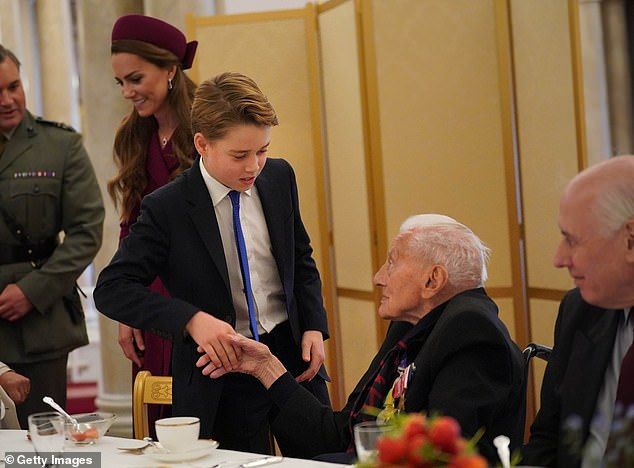 George was snapped beaming as he shook hands with one esteemed veteran