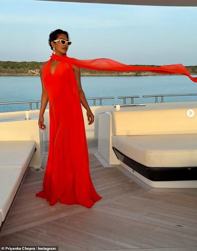 She also looked stunning in a floaty bright red dress as she showed off an elegant evening look