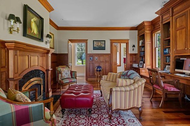 The house also features an elegant office area, decked out in wood paneling and matching cupboards. The office also flaunts another of the home's many fireplaces